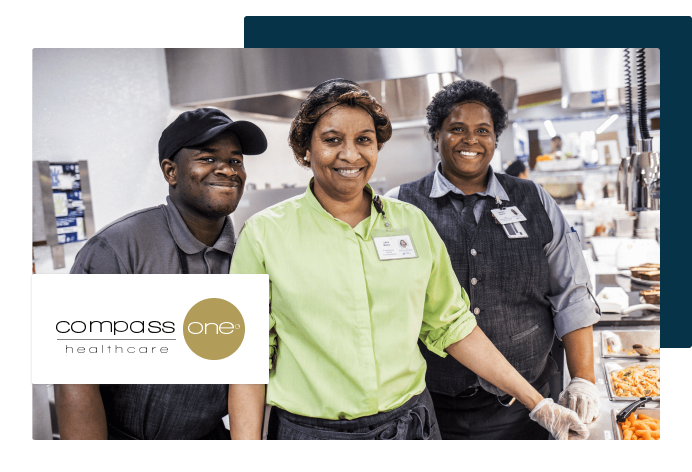 Woman and men in kitchen smiling